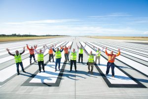 Group of people standing on the Brisbane airport runway